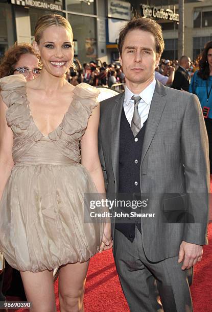 Actress Leslie Bibb and Actor Sam Rockwell pose in front of an Audi on the red carpet of the "Iron Man 2" World Premiere at the El Capitan Theatre on...