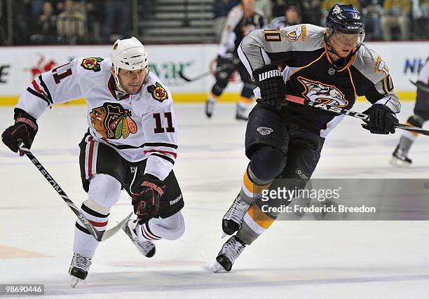 Martin Erat of the Nashville Predators races John Madden of the Chicago Blackhawks for the puck in Game Six of the Western Conference Quarterfinals...