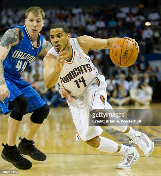 Augustin of the Charlotte Bobcats dribbles past Jason Williams of the Orlando Magic in Game Four of the Eastern Conference Quarterfinals during the...