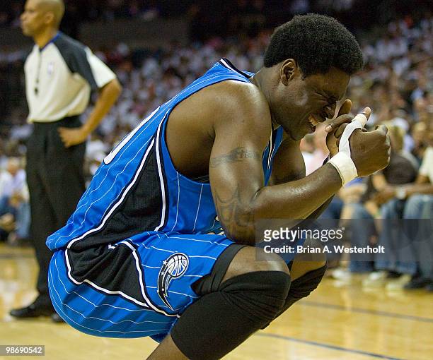 Mickael Pietrus of the Orlando Magic grimaces in pain after being hit in the nose during second quarter action against the Charlotte Bobcats in Game...