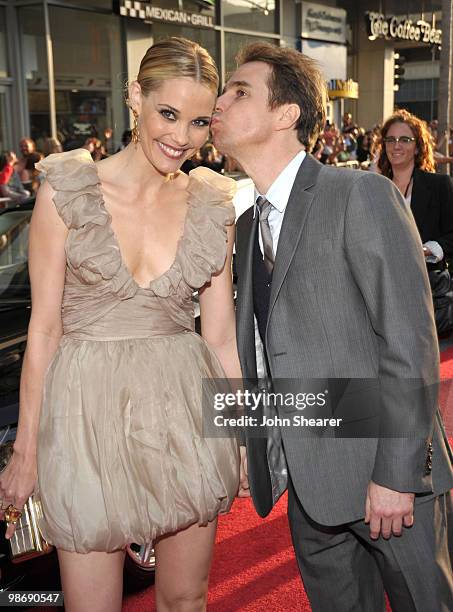 Actress Leslie Bibb and Actor Sam Rockwell pose in front of an Audi on the red carpet of the "Iron Man 2" World Premiere at the El Capitan Theatre on...