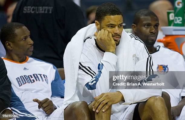 Theo Ratliff, Tyson Chandler and Nazr Mohammed of the Charlotte Bobcats sit on the bench during the final minutes of their game against the Orlando...