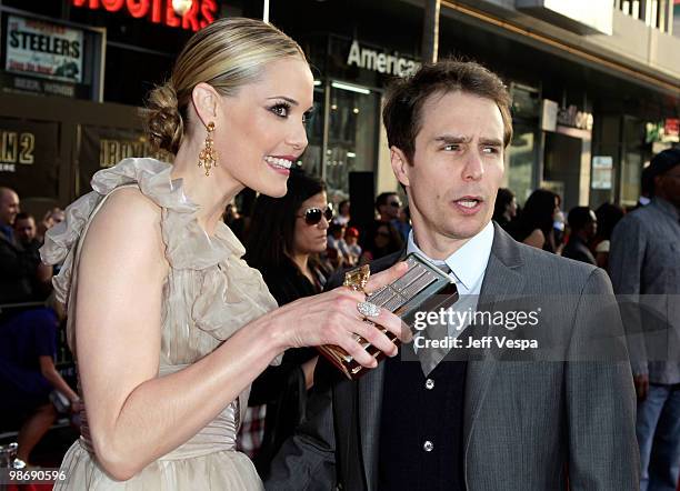 Actors Leslie Bibb and Sam Rockwell arrive at the "Iron Man 2" World Premiere at El Capitan Theatre on April 26, 2010 in Hollywood, California.