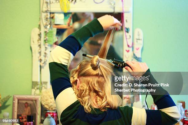 teen girl primping and preening hair - preening stock pictures, royalty-free photos & images