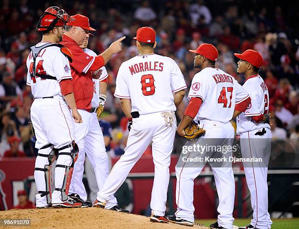 Manager Mike Scioscia of the Los Angeles Angels of Anaheim speaks to his infield players during a pitching change against the Cleveland Indians on...