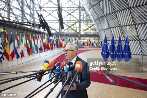 Jean-Claude Juncker, president of the European Commission, speaks to the media as he arrives for a European Union leaders summit in Brussels,...