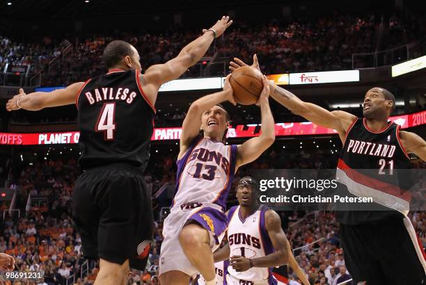 Steve Nash of the Phoenix Suns drives to the basket against Jerryd Bayless and Marcus Camby of the Portland Trail Blazers during Game Five of the...