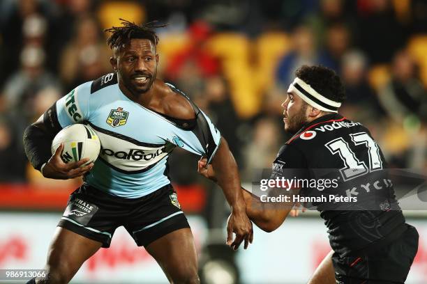 James Segeyaro of the Sharks ties to get past Jazz Tevaga of the Warriors during the round 16 NRL match between the New Zealand Warriors and the...