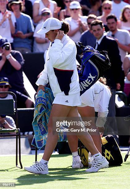 Dejected Martina Hingis of Switzerland leaves the court after losing to Virginia Ruano Pascual of Spain in straight sets during the womens first...