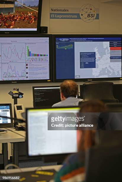 February 2018, Germany, Bonn: Employees of the Bundesamt für Sicherheit in der Informationstechnik sit in front of screens in the national IT centre....