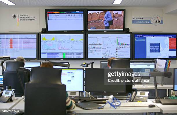 February 2018, Germany, Bonn: Employees of the Bundesamt für Sicherheit in der Informationstechnik sit in front of screens in the national IT centre....