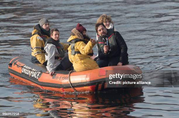 February 2018, Germany, Berlin: Academy Award winner Javier Bardem and Greenpeave employees arrive on a boat at a Greenpeace press conference. The...