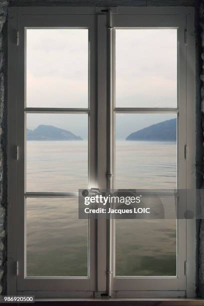 a lake seen through a window, (photomontage). - window montage stock pictures, royalty-free photos & images