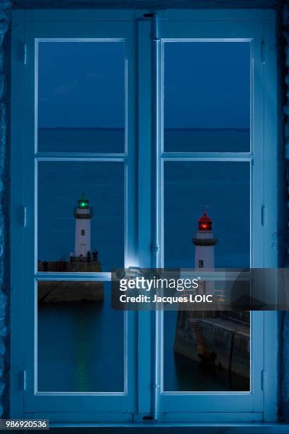 lighthouse seen through a window, (photomontage). - red beacon stock pictures, royalty-free photos & images