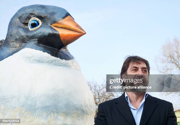 February 2018, Germany, Berlin: Academy Award winner Javier Bardem stands next to a huge pengiun during a Greenpeace press conference. The Spanish...