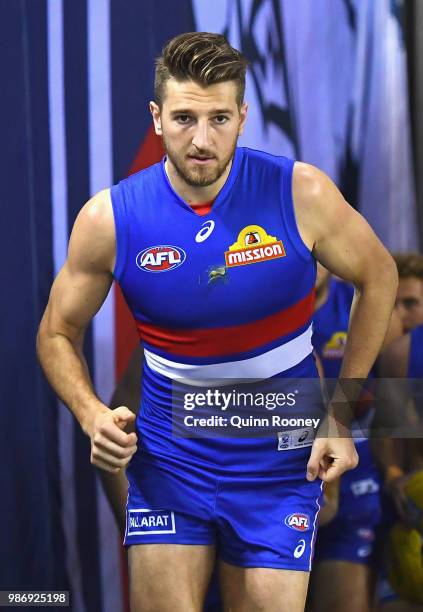 Marcus Bontempelli of the Bulldogs leads his team out onto the field during the round 15 AFL match between the Western Bulldogs and the Geelong Cats...