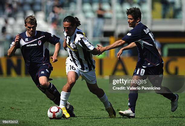 Mauro German Camoranesi of Juventus FC is challenged by Vladimir Koman and Paulo Vitor De Souza Barreto of AS Bari during the Serie A match between...