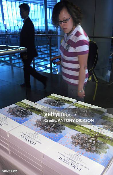 Potential investor looks at copies of the L'Occitane prospectus at the HSBC headquarters in Hong Kong on April 27, 2010. French cosmetics group...