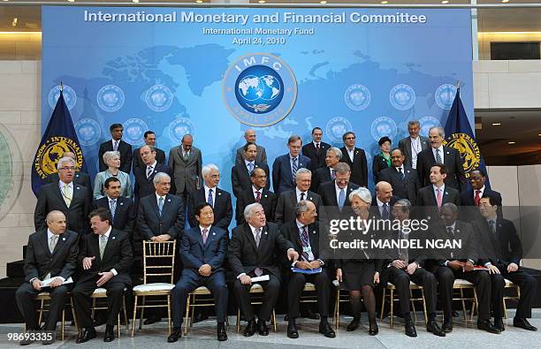 France�s Finance Minister Christine Lagarde takes her seat to pose in a group photo with from left, front row: Brazil's Finance Minister Guido...