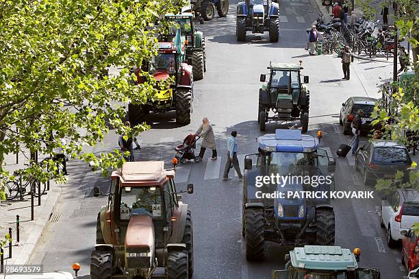 French farmers drive their tractors in Paris on April 27, 2010 as they demonstrate against wages cut and to denounce the European Farm Policy. The...