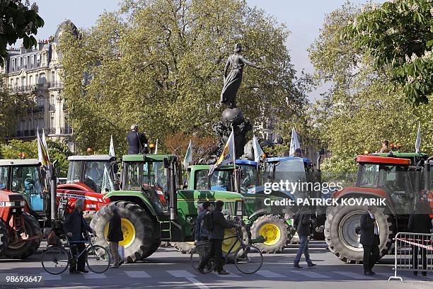 French farmers drive their tractors in Paris on April 27, 2010 as they demonstrate against wages cut and to denounce the European Farm Policy. The...