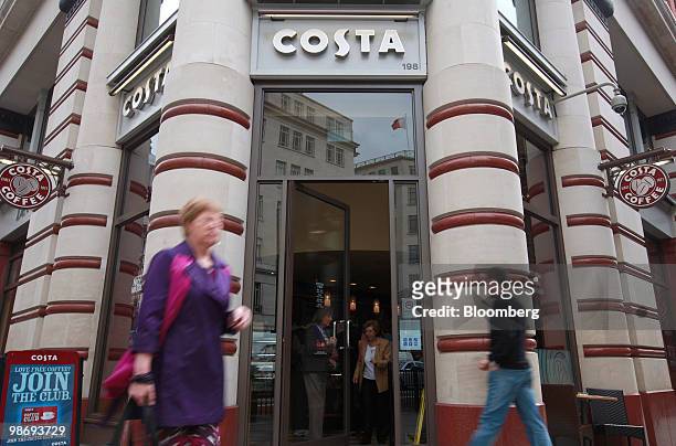 Pedestrians walk past a Costa Coffee shop in London, U.K., on Monday, April 26, 2010. Whitbread Plc., which own Costa Coffee, announce earnings on...