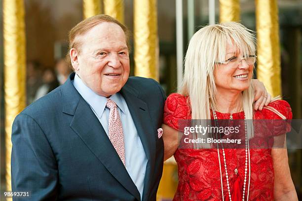 Sheldon Adelson, chairman and chief executive officer of Las Vegas Sands Corp., left, and his wife Miriam Adelson arrive for the opening ceremony of...