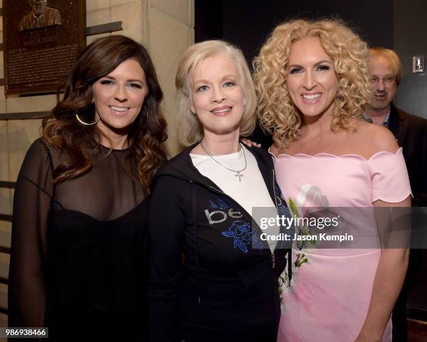 Karen Fairchild of Little Big Town, Norah Lee and Kimberly Schlapman of Little Big Town take photos during the Country Music Hall of Fame and...