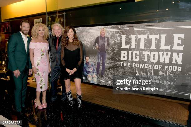 Jimi Westbrook, Kimberly Schlapman, Phillip Sweet and Karen Fairchild of Little Big Town take photos during the Country Music Hall of Fame and Museum...