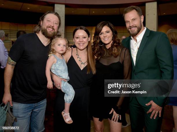 Cary Barlowe, Hillary Lindsey, Karen Fairchild and Jimi Westbrook of Little Big Town take photos during the Country Music Hall of Fame and Museum's...