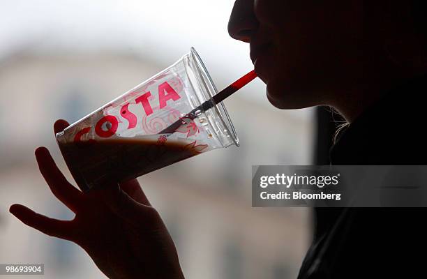 Customer drinks a beverage in a Costa Coffee shop in London, U.K., on Monday, April 26, 2010. Whitbread Plc., which own Costa Coffee, announce...