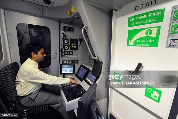 Delhi Metro Station Controller/Train Operator trainee takes the controls in a train simulator at the Delhi Metro Training Institute in New Delhi on...