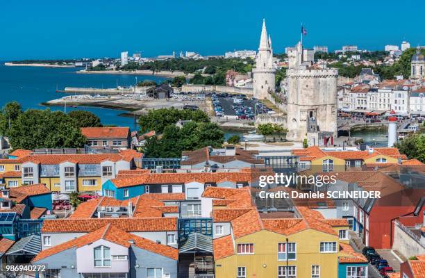 france, charente-maritime, la rochelle, towers of la lanterne and saint nicolas behind gabut neighborhood - charente maritime stock pictures, royalty-free photos & images