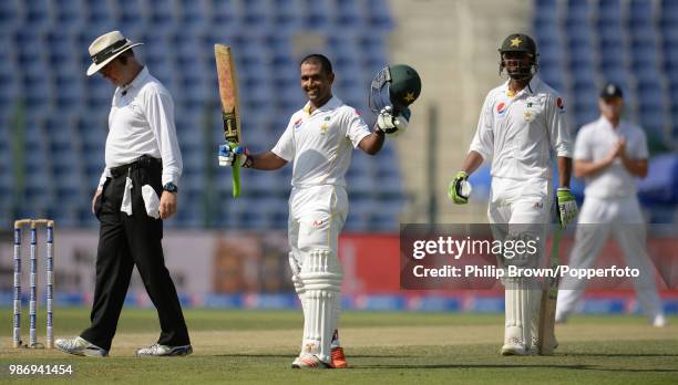 Asad Shafiq of Pakistan celebrates reaching his century his innings of 107 in the 1st Test match between Pakistan and England at the Sheikh Zayed...