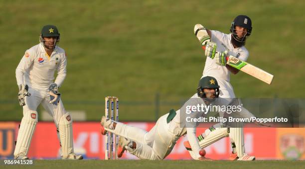 England opener Moeen Ali plays the ball past Pakistan fielder Shan Masood during the 1st Test match between Pakistan and England at the Sheikh Zayed...