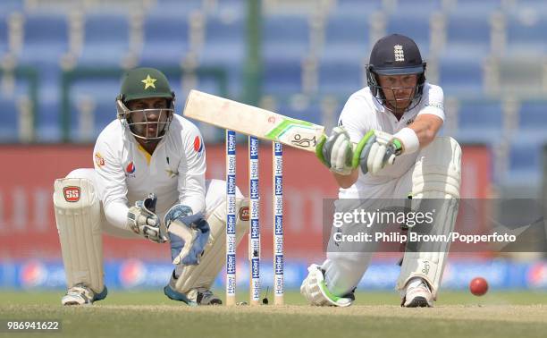 England batsman Ian Bell prepares to sweep the ball watched by Pakistan wicketkeeper Sarfraz Ahmed in the 1st Test match between Pakistan and England...