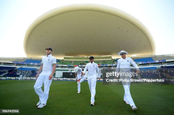 England's Ben Stokes, Ian Bell and Joe Root take to the field as Stuart Broad checks his boots on day five of the 1st Test match between Pakistan and...