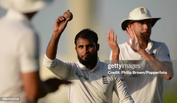 Adil Rashid salutes the crowd with the innings ball as he leaves the field after taking five wickets on day five of the 1st Test match between...