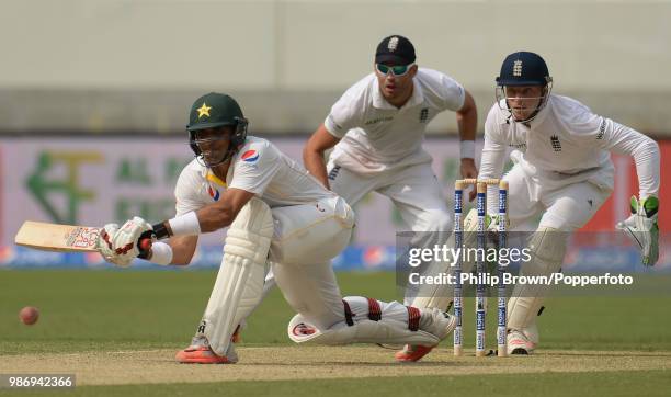 Pakistan captain Misbah-ul-Haq prepares to sweep the ball during his innings of 102 as England wicketkeeper Jos Buttler reacts in the 2nd Test match...