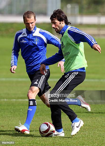 Ruud van Nistelrooy and David Rozehnal compete for the ball during the Hamburger SV training session at HSH Nordbank Arena on April 27, 2010 in...