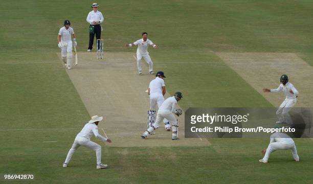 England captain Alastair Cook is caught by substitute fielder Ahmed Shehzad of Pakistan off the bowling of Yasir Shah for 65 runs during the 2nd Test...