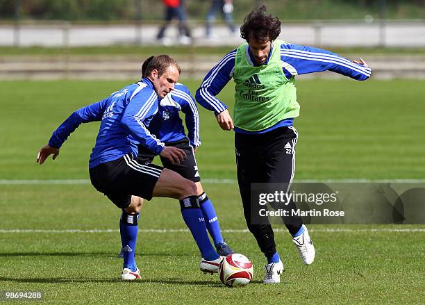 Ruud van Nistelrooy and David Rozehnal compete for the ball during the Hamburger SV training session at HSH Nordbank Arena on April 27, 2010 in...