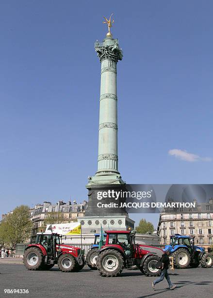 French farmers drive their tractors on the Place de la Bastille in Paris on April 27, 2010 as they demonstrate against wages cut and to denounce the...