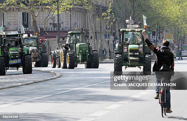 French farmers drive their tractors in Paris on April 27, 2010 as they demonstrate against wages cut and to denounce the European Farm Policy. The...