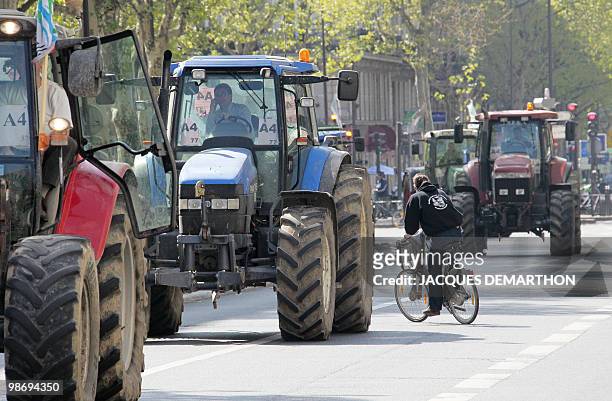French farmers drive their tractors in Paris on April 27, 2010 as they demonstrate against wages cut and to denounce the European Farm Policy. The...