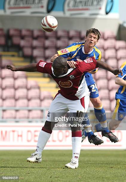 Adebayo Akinfenwa of Northampton Town contests the ball with Shane Cansdell-Sherriff of Shrewsbury Town during the Coca Cola League Two Match between...