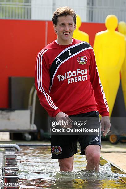 Goalkeeper Rene Adler wades through water during the training session of Bayer Leverkusen at the training ground on April 27, 2010 in Leverkusen,...