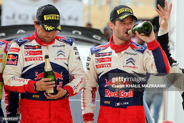 French driver Sebastien Loeb and his co-driver Daniel Elena celebrate their win at the end of the Jordan Rally in Amman on April 3, 2010. Loeb won...