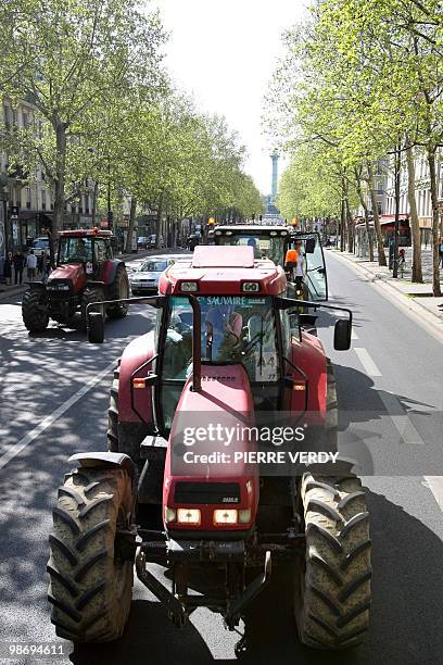 French farmers drive their tractors next to the place de la Bastille in Paris on April 27, 2010 as they demonstrate against wages cut and to denounce...