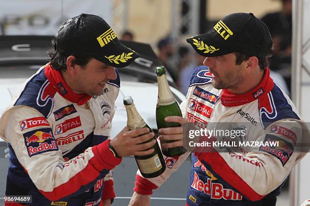 French driver Sebastien Loeb and his co-driver Daniel Elena celebrate their win at the end of the Jordan Rally in Amman on April 3, 2010. Loeb won...